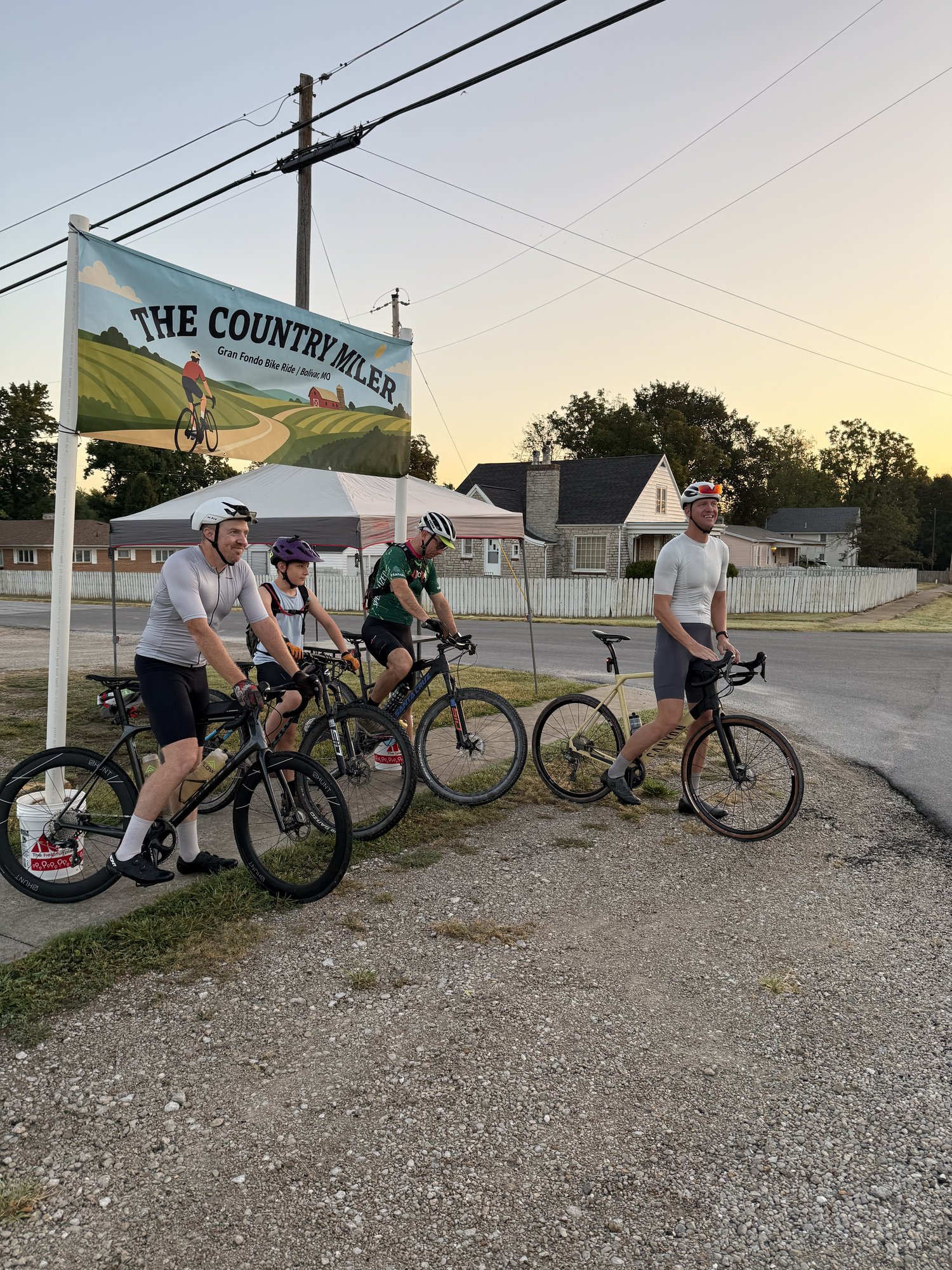 Country Miler 2026 — pack of riders on the course with the event banner in frame