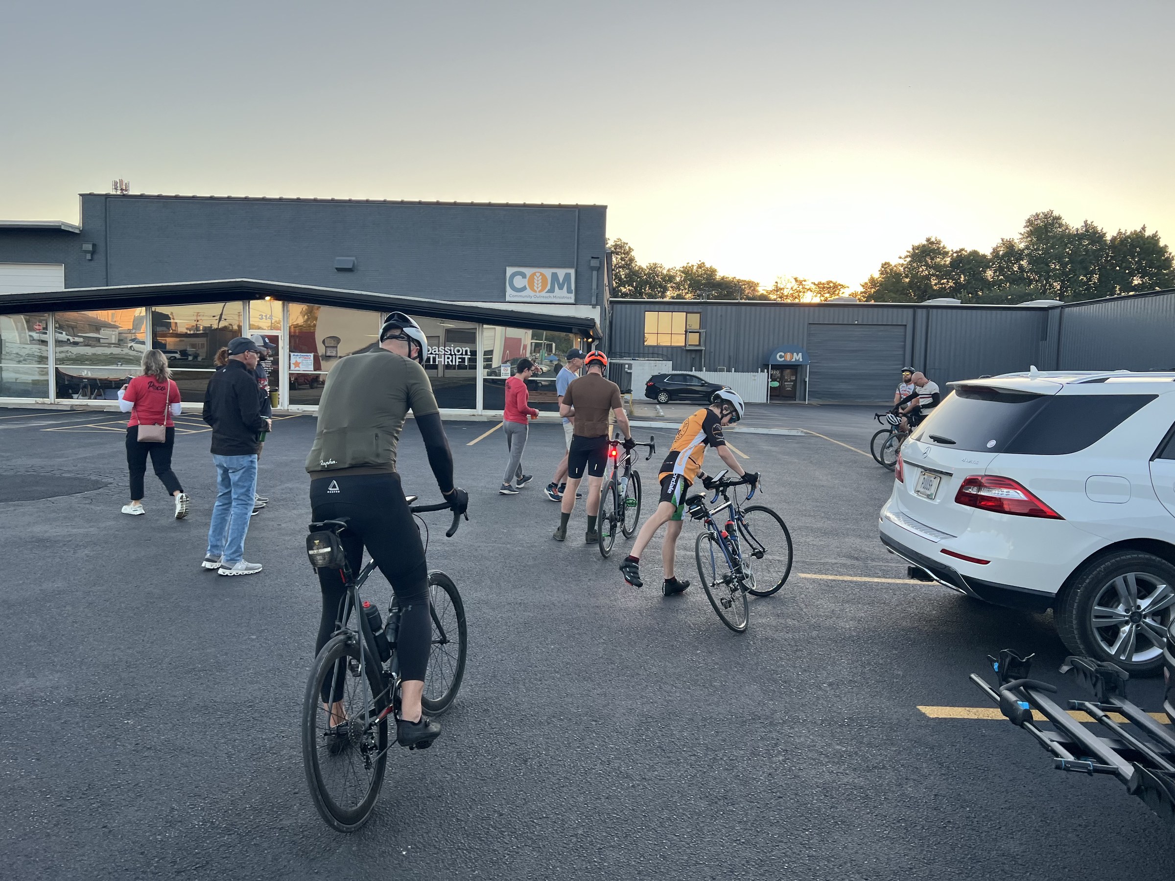 COM parking lot scene with a rider in a red PoCo tee